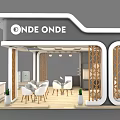 ONDE ONDE Exhibition Booth With White Tables Chairs Wooden Decorations And Green Plants