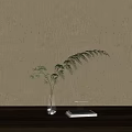 Decorative Glass Vase With Bamboo Leaves Against Light Colored Wall