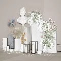 Floral Installation with White Bust Statue Geometric Pedestals Pink White Flowers Candles and Scattered Petals