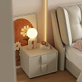 Modern Beige Nightstand With Round Lamp Books And Bedside Artwork