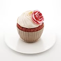 Red Velvet Cupcake With White Cream Frosting And Pink Rose Decoration On White Plate