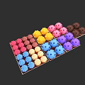 Assorted Colorful Chocolate Truffles Arranged in Compartments with Vibrant Hues