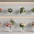 Various Flower Bouquets in Transparent Vases on White Layered Shelves