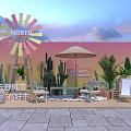 Colorful Windmill Outdoor Seating Area With Umbrella Cacti Plants And Stone Pavement