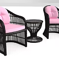 Black Rattan Single Sofa with Pink Cushions and Round Rattan Side Table