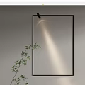Modern Wall Lamp with Black Frame Illuminating Gray Wall and Bamboo Plant