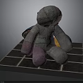 Patchwork Fabric Doll With Various Colors Sitting On Blue Tiled Platform