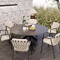 Outdoor Round Dining Table and Woven Chairs Set with Patio Brick Wall and Floor Lamp