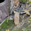 Broken Old Weathered Wooden Planks And Metal Sheets In Ash Debris With Overgrown Grass
