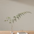 Decorative Glass Vase With Bamboo Leaves Against Light Colored Wall