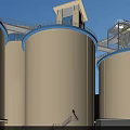 Industrial Plant Featuring Large Silos Green Lawn And Blue Sky With White Clouds