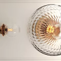 Elegant Modern Wall Sconce With Transparent Cut Glass Shade Brass Base And Warm Light Glow