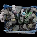 Recycled Daily Necessities In Blue Plastic Basket Filled With Old Cloths And Bottles