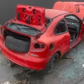 Red Damaged Car With Crashed Front End Open Hood And Broken Glass