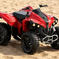 Red All Terrain Vehicle On Sandy Beach With Four Wheel Large Tires And Black Seat
