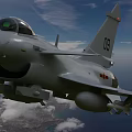 Two Military Fighter Jets Flying In Blue Sky With White Clouds Over Land And Ocean