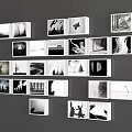 Photo Wall Featuring White Frames Displaying Black And White Photos On Gray Background Wall