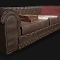Vintage Tufted Leather Double Sofa With Book Newspapers And Red Plaid Blanket