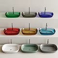 Various Colors Modern Design Washbasins Arranged on Three White Bathroom Shelves