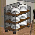 Three Tier Metal Mesh Storage Rack With Stacked Silver Discs On Wooden Shelves And Wheels