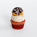 Delicious Red Cupcake With White Frosting Gold Sprinkles And Chocolate Topping