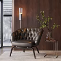 Tufted Black Leather Lounge Chair with Floor Lamp Side Table Green Plant and Wooden Wall