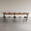 Modern Long Wooden Dining Table with Black and Metallic Stools and White Plates