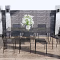 Modern Metal Table And Chairs Set With Flower Vase Striped Stools And Potted Plants