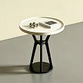 Modern Side Table With White Round Top Black Base Magazine And Metallic Balls