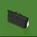 Dark Gray Quilted Handbag With Silver Metal Hardware On Green Background