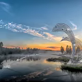 Metal Bird Shaped Sculpture by the Lake with Sunset Mist Trees and Flying Birds