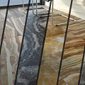 Marble Patterned Floor Tiles With Brown Beige Black Colors Neatly Arranged And Metal Chair Legs