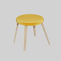 Round Yellow Stool with Upholstered Seat and Wooden Legs in Minimalist Interior with Gray Floor