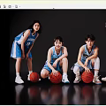 Female basketball players in blue WINGS jerseys holding basketballs posing together in black studio