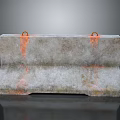 Heavy Duty Concrete Barrier With Orange Lifting Rings And Rusty Surface Stains