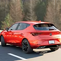 Red Sporty Compact Car Driving On Scenic Mountain Road With Clear Sky