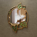 Round Mirror With Golden Frame And Green Leaf Decorations Reflecting Bedroom Bed And Nightstand