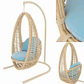 Wicker Hanging Chair With Blue Cushion And Woven Frame Structure