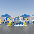 Professional Commercial Equipment with Blue Tent Style Booths Yellow Decorations and Display Stands