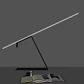 Modern Adjustable Desk Lamp With Sleek Pole And Open Book On Dark Desk