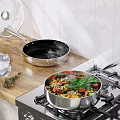 Quality Cookware Set With Non Stick Frying Pan Cooking Fresh Vegetables And Herbs On Stovetop