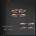 Three Modern Layered Circular Chandeliers With Glass Shades And Metal Frames