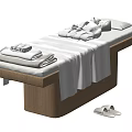 Comfortable Massage Bed with Wooden Frame White Sheets Folded Towels Blankets and Side Slippers