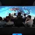 Modern Tech Cinema With Large Screen Illuminated AOC Sign And Dinosaur Scene