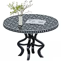 Round Black White Patterned Dining Table With Curved Metal Legs And White Vase Green Plant