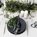 Elegant Tableware Set With Black Plates Napkins Greenery Pine Cones Candles And Wine Glasses