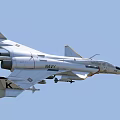 US Navy White Fighter Jet In Flight With Attached Missiles And Military Markings
