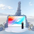 Elegant Stage Featuring Large Colorful Screen Person in Black Blue Floral Decorations and Sky Background