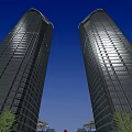 Modern Glass Office Towers Illuminated at Night With Blue Sky and Greenery at Base