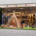 Shopping Mall Window Display With Teepee Yellow Coat Wooden Boxes Green Grass And Plants